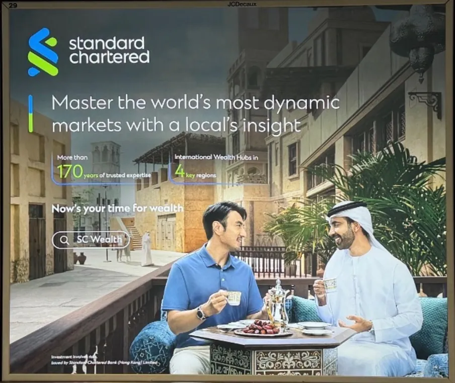 Standard Chartered campaign creative featuring booked talent in a lifestyle setting